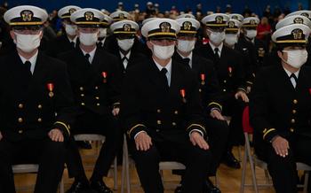 Officer Candidate School students sit at attention during their graduation ceremony at Officer Training Command Newport, Rhode Island, Dec. 3, 2021. 