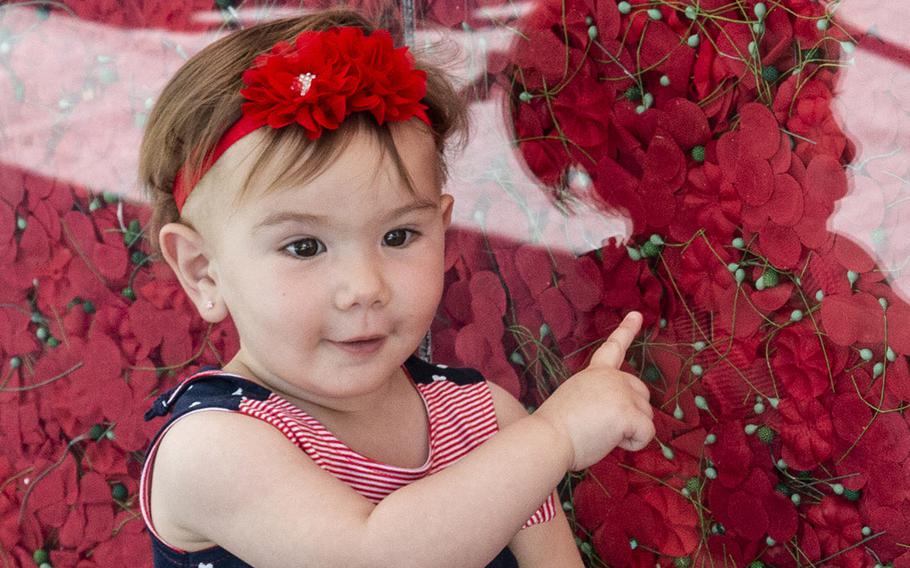 Thirteen-month-old Ava Khoury points out the flowers on USAA's Poppy Wall of Honor on the National Mall in Washington, D.C., May 24, 2019.