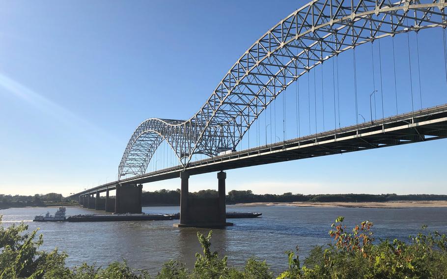 A barge moves north on the Mississippi River under the Interstate 40 bridge connecting Tennessee and Arkansas on Sept. 29, 2022, in Memphis, Tenn. The unusually low water level in the lower Mississippi River is causing barges to get stuck in the muddy river bottom, resulting in delays. The U.S. Coast Guard said Tuesday, Oct. 4, 2022, that at least eight “groundings” of barges have been reported in the past week, despite low-water restrictions on the barge loads. 