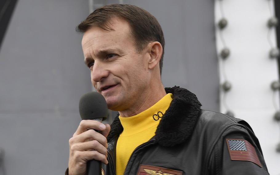 In a Nov. 14, 2019 photo, Capt. Brett Crozier, then commanding officer of the aircraft carrier USS Theodore Roosevelt, addresses the crew during an all-hands call on the ship's flight deck.