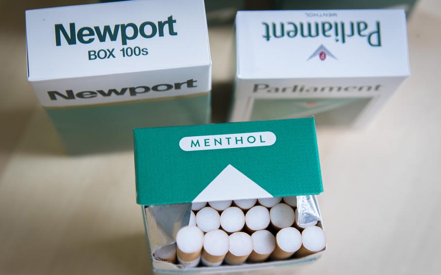 In a photo illustration, packs of menthol cigarettes sit on a table. 