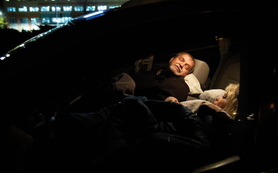 Dale Pearson and Sandra-Kay Pearson rest in their car outside of a hospital in Knoxville, Tenn., on Nov. 17. 