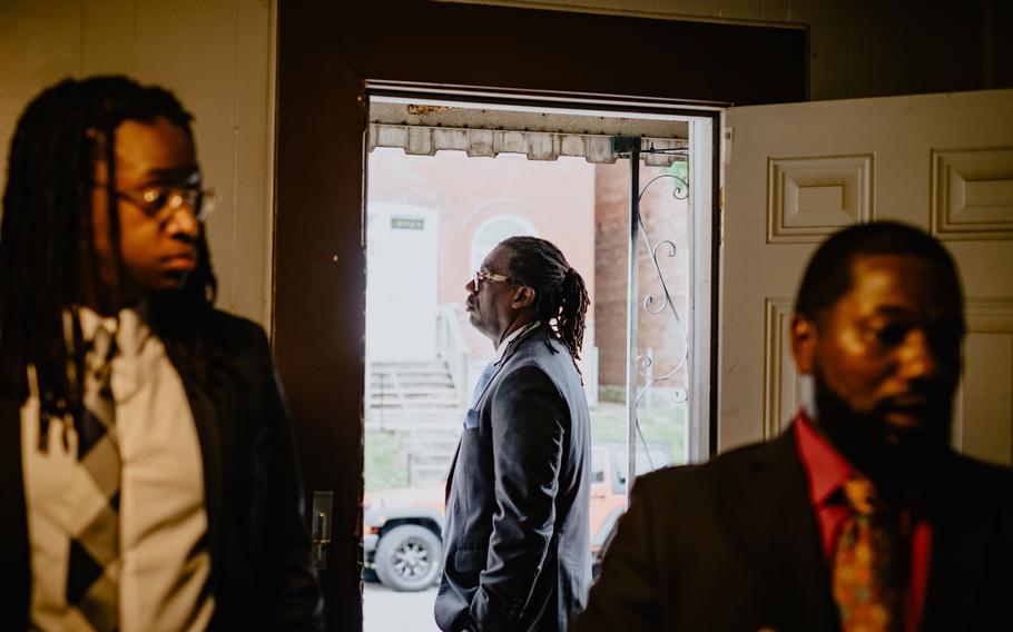 Attorneys Emanuel Powell, left, and Jerryl Christmas accompany Don Clark Jr. to the home of his late father in St. Louis. Clark’s father was killed by police officers executing a no-knock raid at multiple addresses in 2017. 
