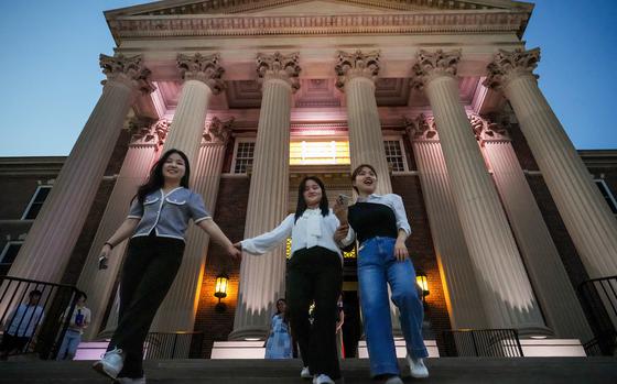 North Korean refugees, from left, Bella Ha,  Lily Jo and Grace Kang walk down the steps of Dallas Hall after touring the building following the "A Path to Peace: The Hopeful Hearts of North Korea" event at SMU on Monday, April 29, 2024. The event was hosted by the Liberty in North Korea chapter at SMU. 