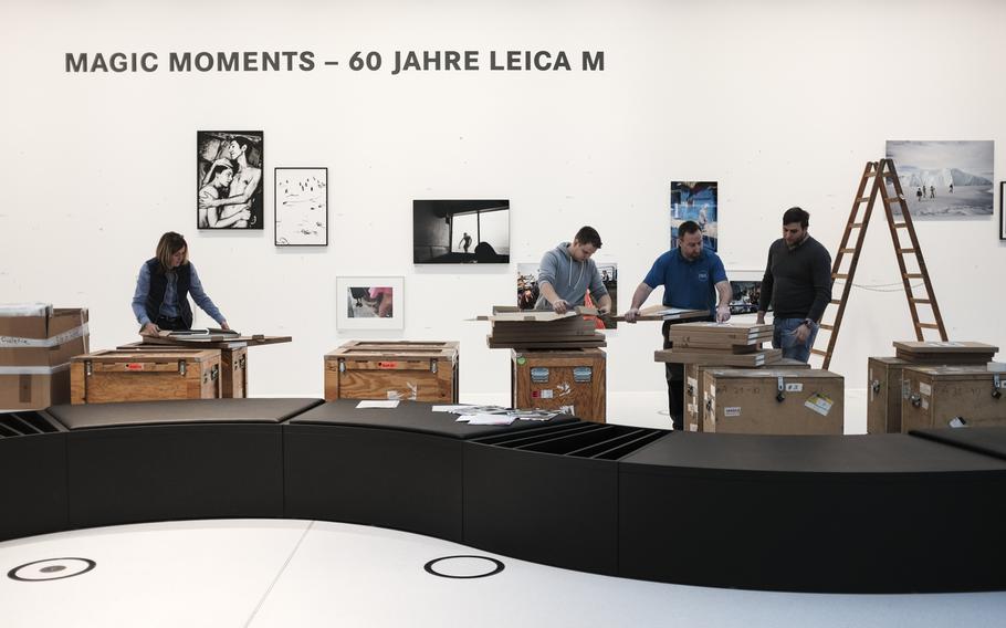 Leica employees change photo exhibits at the Leica manufacturing and administrative complex in Wetzlar, Germany,  Jan. 6, 2015.

