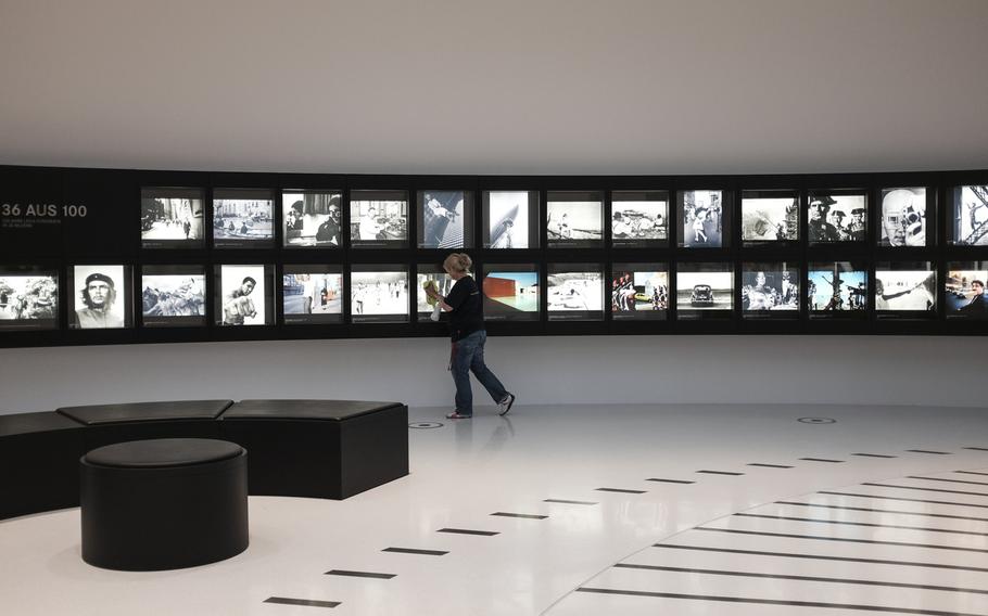 A janitor cleans the glass on the "36 Aus 100" photo exhibit that highlights 36 iconic images made over Leica's 100-year history at the firm's manufacturing and administrative complex in Wetzlar, Germany, Jan. 6, 2015.

