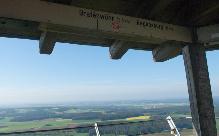 The walkway around the top of the observation tower atop the Rauher Kulm mountain, near Grafenwoehr, Germany, has information signs that show visitors what towns and cities are visible in the distance. 

