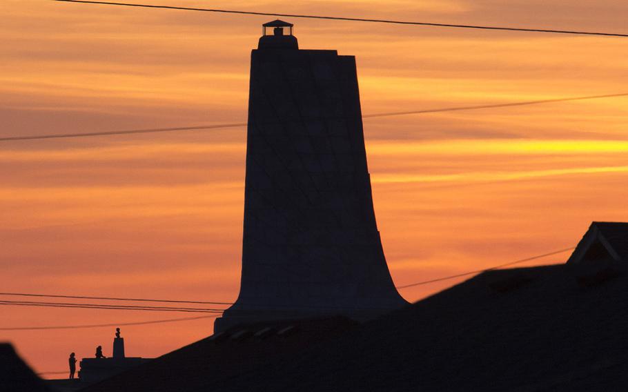 The Wright Brothers National Memorial in Kitty Hawk, N.C., as seen at sunset from the beach.