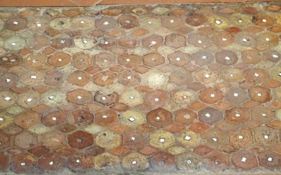 One of the small rooms in Vicenza's Criptoportico Romano contains a fragment of a decorative flooring made of cooked clay - basically, brick. The white spots in the hexagons are marble. 


