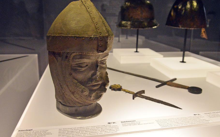 A 13th-century head of a knight that was found in Bamberg, Germany, is one of the more than 150 objects on display at the  ''Richard Lionheart King – Knight – Prisoner'' exhibit at the Historical Museum of the Palatinate in Speyer, Germany. In the background are a dagger, a sword and two helmets. 
