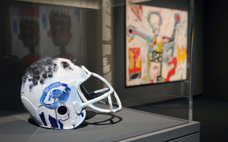 ''Untitled (Football Helmet)'' is one of the works by Jean-Michel Basquiat on display at ''Basquiat. Boom for Real,'' an exhibit at the Schirn Kunsthalle in Frankfurt, Germany. In the background is ''Untitled.'' The exhibit runs until May 27, 2018. Artworks: © VG Bild-Kunst Bonn, 2018 & The Estate of Jean-Michel Basquiat, Licensed by Artestar, New York.
