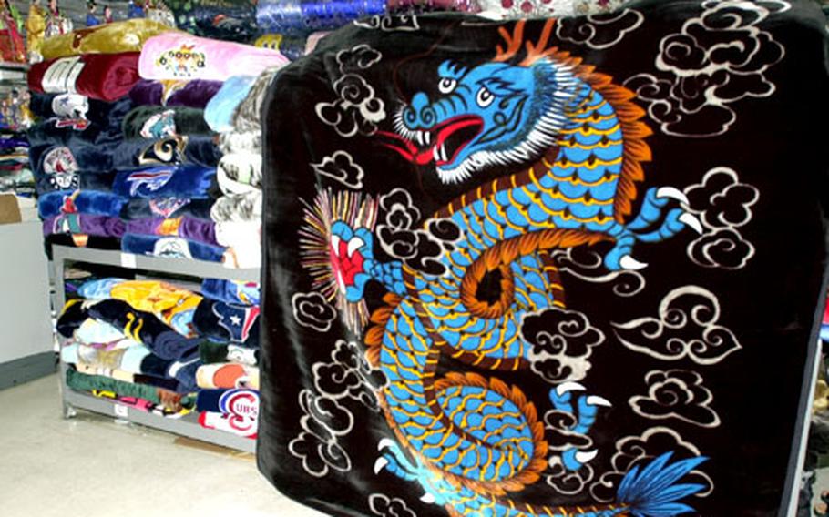 Mink blankets are among the most popular "must-have" items for those visiting or living in Korea. Here a shop has stacks of blankets in every color and design, ranging in price from $18 to $25.00.