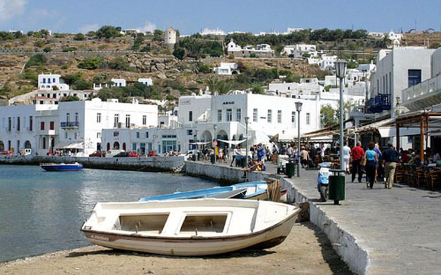 Boats sit along the stone walkway along the main harbor of Mykonos where much of the island’s life and activities occur.