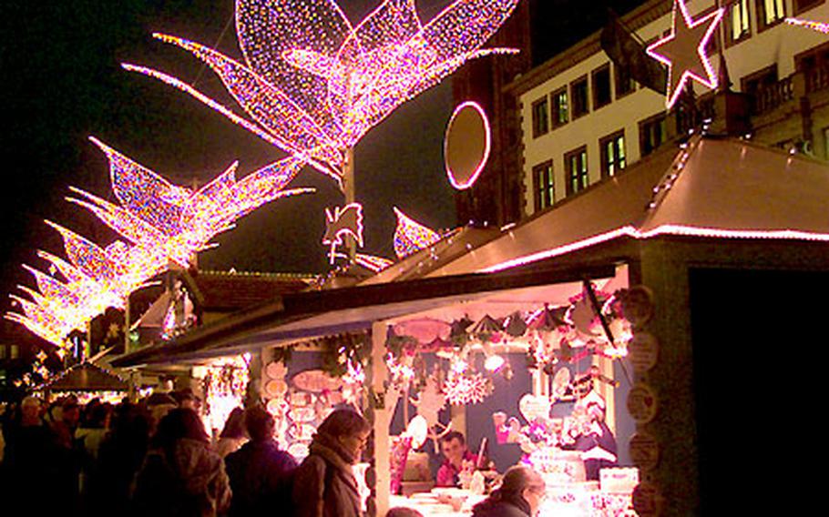 Lights in the form of lilies brighten the Wiesbaden, Germany, Christmas market.