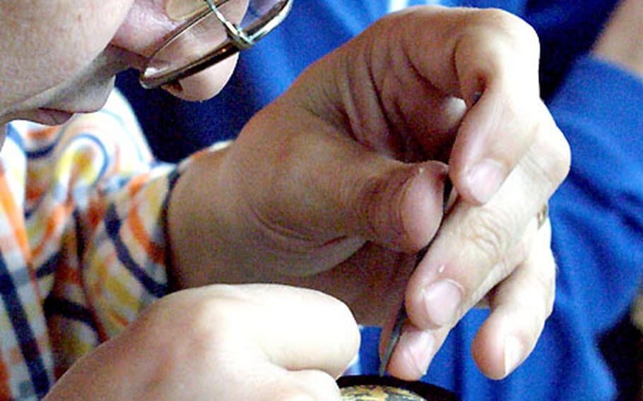 Eldefonso Suarez creates a piece of damascene handicraft at Fabrica Bermejo in Toledo, Spain. The damascene procedure requires creativity and the steady hand of a surgeon on small pieces.