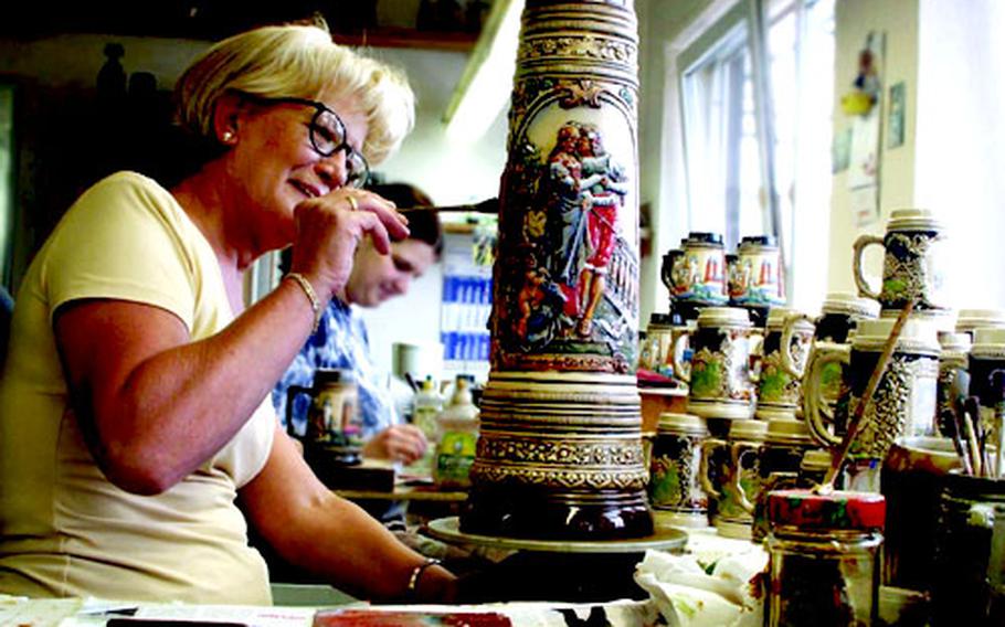 Artists at Zöller & Born paint steins by hand with ceramic enamel paint. The company is based in Hillscheid, Germany, near Koblenz.