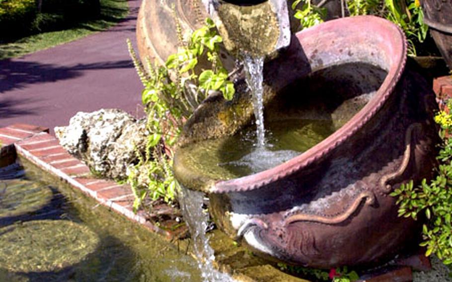 Running water flows out of two large urns near the entrance of Okinawa’s Southeast Botanical Gardens in Okinawa City, Okinawa.