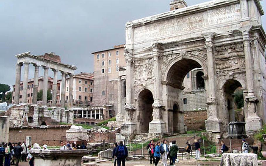 What's left of the Forum teeters before a group of tourists on a Sunday morning.