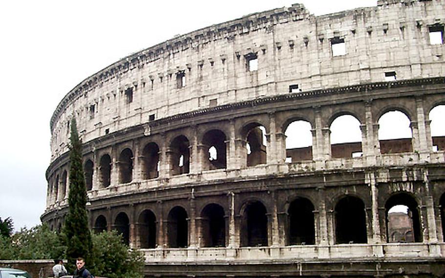 The Roman Colosseum curves broadly in Rome, not far from the ancient Forum and a modern-day subway stop.