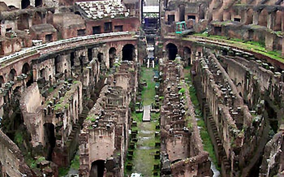 Tourists gawk at the massive interior of the Colosseum, the largest Roman amphitheater in the world.