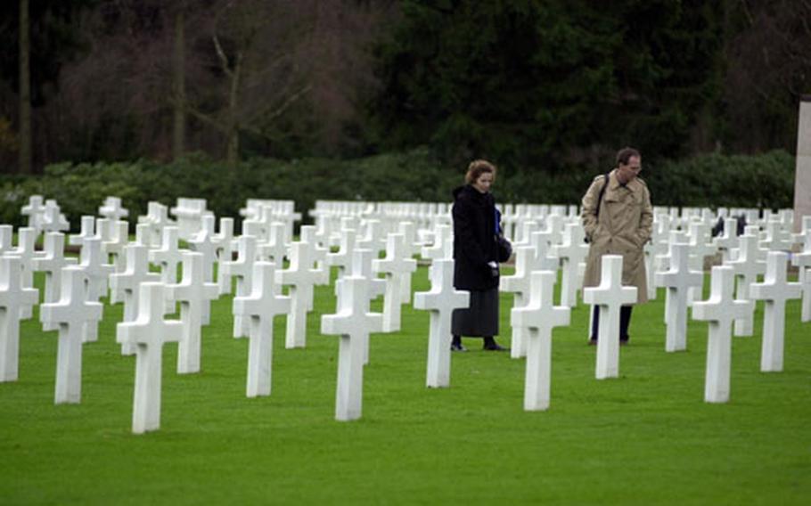 Visitors walk among the headstones at the Luxembourg American Cemetery and Memorial in Luxembourg.