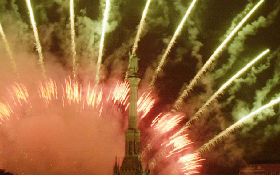 Fireworks explode behind a statue of Christopher Columbus in Madrid, Spain, Monday, Jan. 1, 2001, to celebrate the arrival of the 21st century.