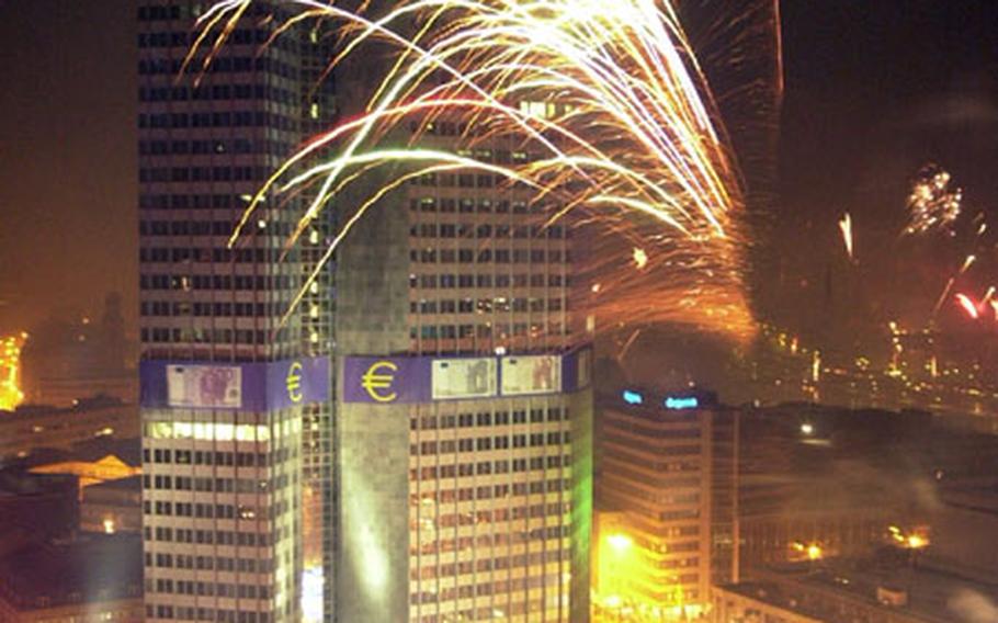 Fireworks illuminate the sky around the European Central Bank headquarters in Frankfurt, Germany, during New Year celebrations, Tuesday, Jan. 1, 2002.