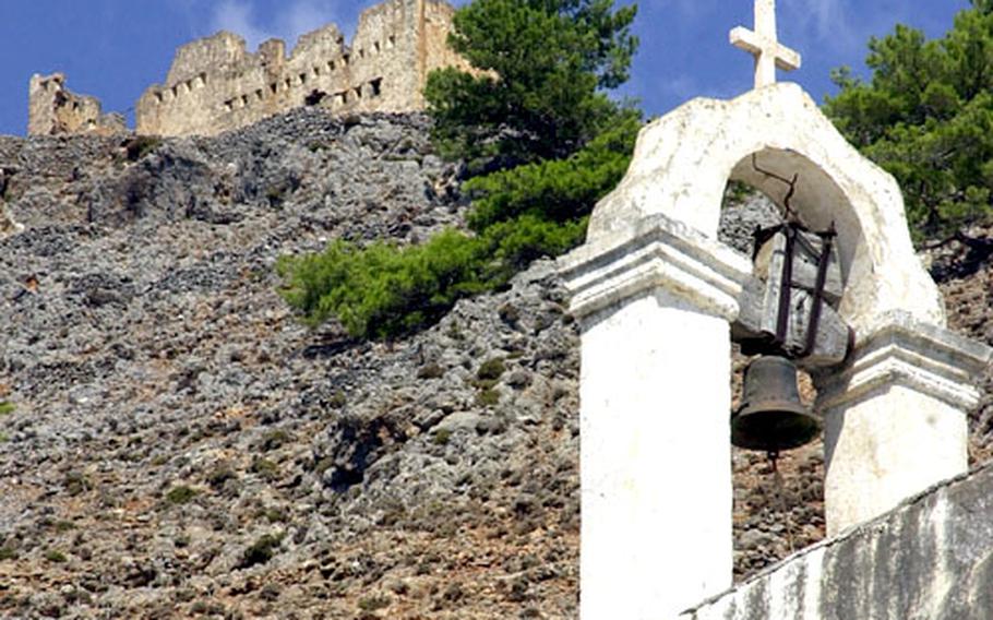 The ruins of a castle tower over the bell tower of a Greek Orthodox chapel at Agia Roumeli are visible on the way to or from the Samaria Gorge.