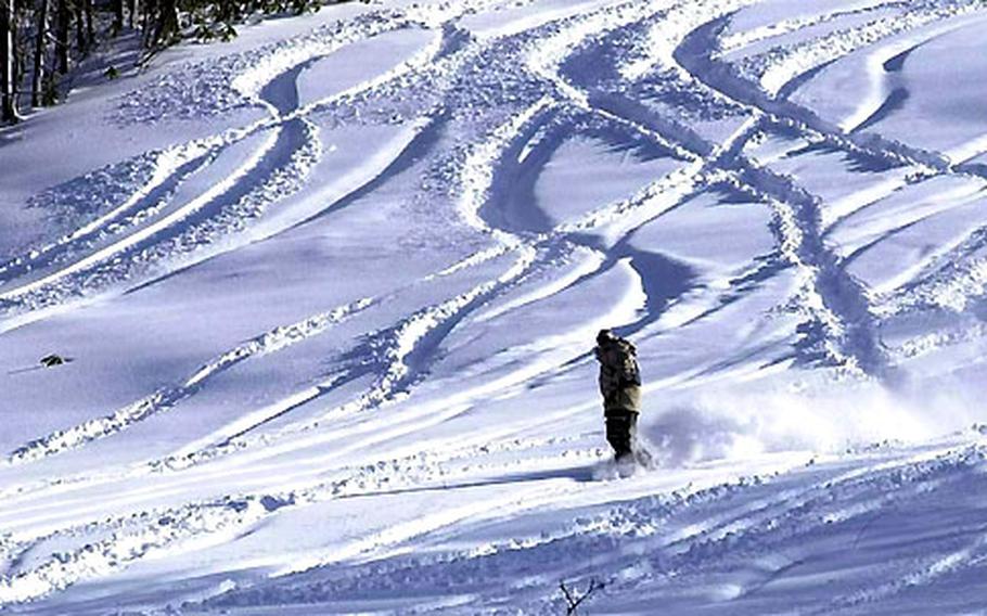 A snowboarder cuts through fresh-fallen, powdery snow on a hillside at Mount Tamoyadaki in the Hakkoda Mountains, 50 miles west of Misawa Air Base in northern Japan.
