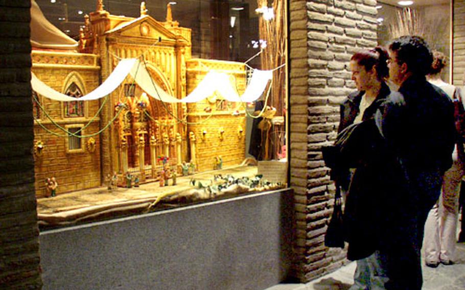 Passers-by in Toledo, Spain, look at a replica of a church made of marzipan, a confection made of ground almonds, sugar and egg whites. The display was outside the Santo Tomé bakery shop in the heart of the city.