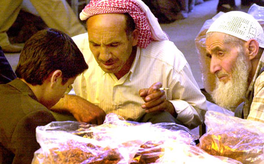 Turkish men check out kilos of bulk tobacco at a stall in Sanliurfa’s bazaar.