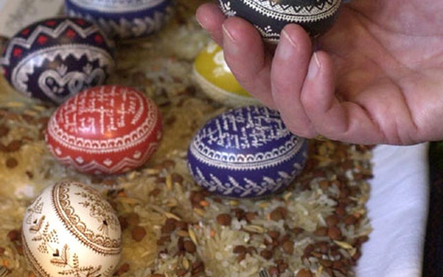 Choosing an egg at an Easter Egg market in Seligenstadt, Germany. These are decorated in the traditional style of northern Hesse. The markets are popular places in the Easter season, and collecting eggs can be an expensive hobby.