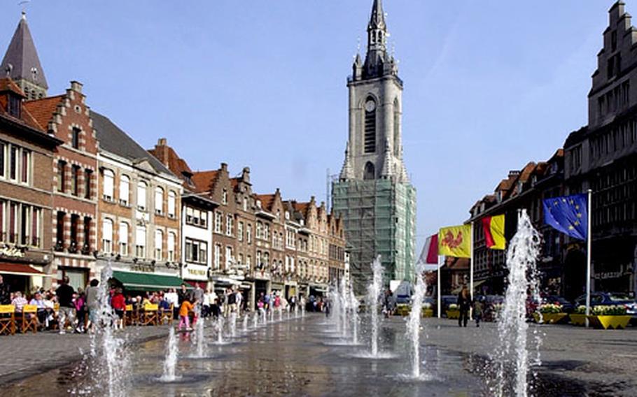 The Grand Place (main square) of Tournai, Belgium. At right is the Belfry, built between the 12th and 14th centuries, and at left one of the five towers of Notre-Dame cathedral peeks over the rooftops.