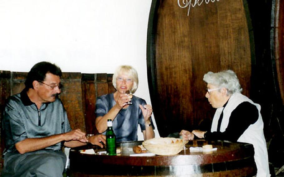 The Lavaux wine region in Switzerland is noted for excellent white wines, including one called Epesses after the village of the same name where it grows. Here, visitors sample the wine at the Caveau des Vignerons.