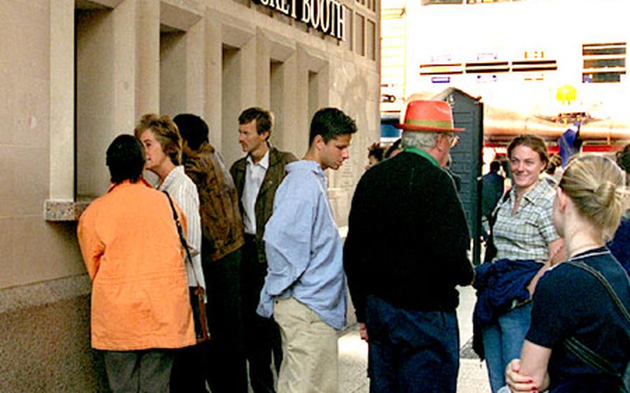 Patrons line up outside the Half Price Ticket Booth on London’s Leicester Square.