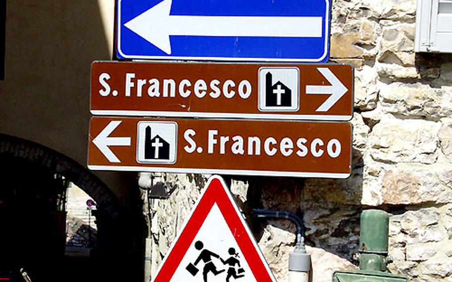 In Assisi, signs point in opposite directions to San Francesco, the Roman Catholic church that contains the remains of St. Francis.