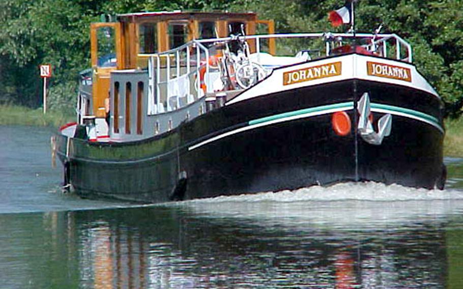 Formerly a dredger and carrier of carnival equipment, the 80-foot, 60-ton canal boat Johanna was converted in 1992 to a passenger barge. Here, she cruises near Germany in the French Alsace region. The Johanna has its own captain and mate who do most of the nautical work, leaving passengers to enjoy themselves.