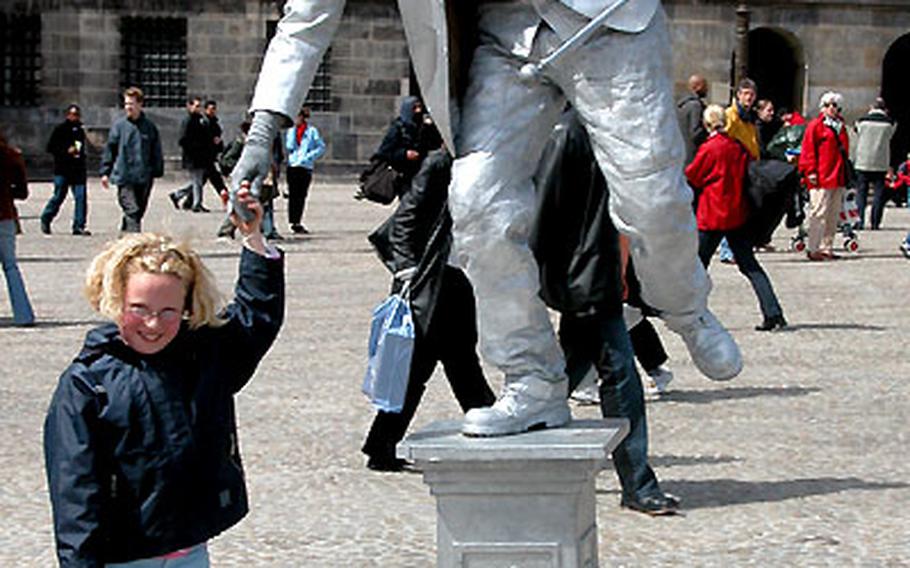 A mime entertains tourists in Amsterdam.