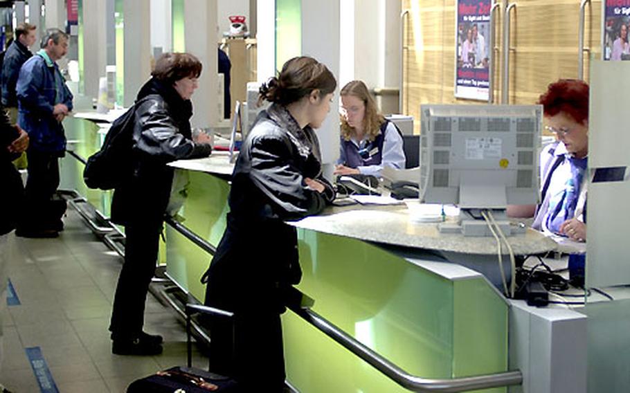 Travelers buy international train tickets at the station in Frankfurt, Germany. Eurail tickets are also available at the international counters.