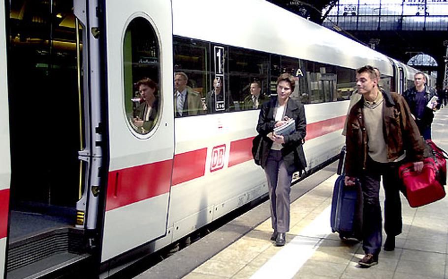 Travelers board a train at the station in Frankfurt, Germany.