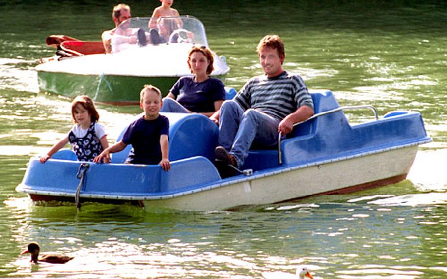 Families enjoy a summer day on the Kleinhesselohersee in Munich, Germany’s English Garden. Working something into the travel schedule just for kids will keep the whole family happy.