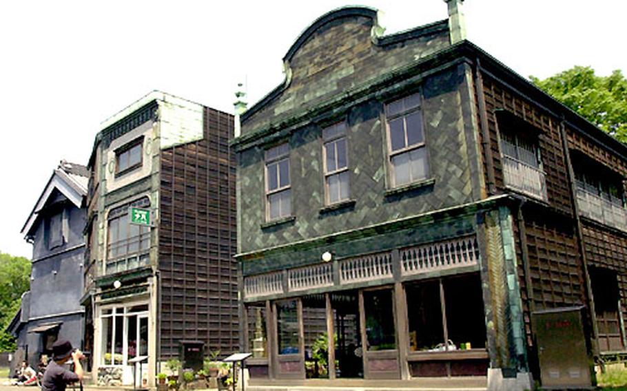 A photographer snaps a photo of a few of the buildings that were built in the 1920’s and were director Hayao Miyazaki’s inspiration for many of the scenes in his movie “Spirited Away.”