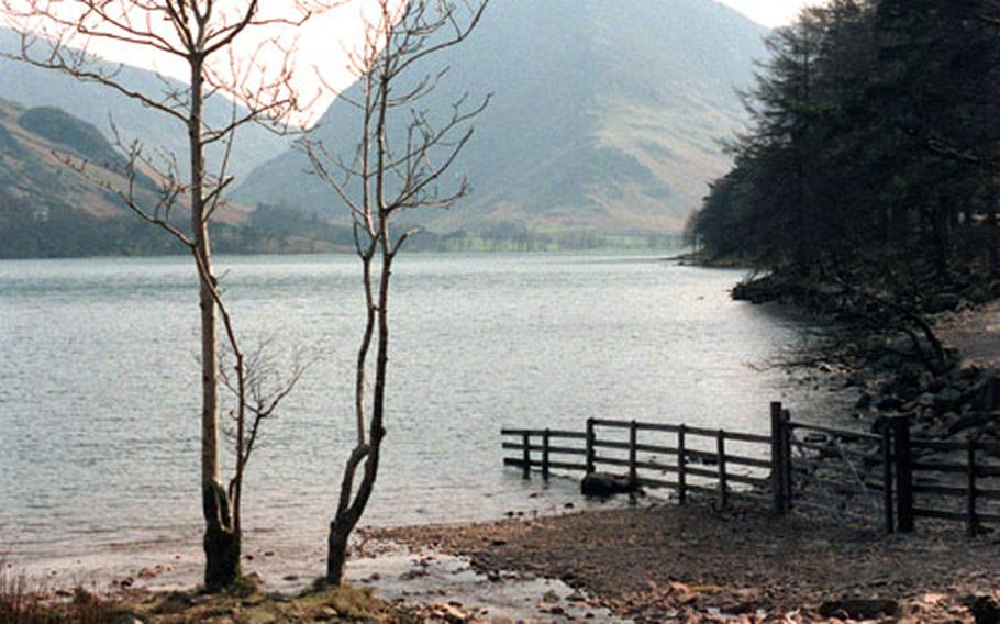 The hills and quiet water of Buttermere Lake make for a nice resting point on the Coast to Coast Walk. It is in the Lake District, the first of three national parks crossed by the walk.