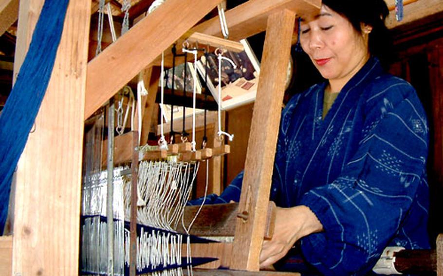 Setsuko Nakama weaves traditional Okinawan hanaui cloth on a loom in a 180-year-old farmhouse at Ryukyu Mura.