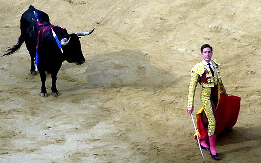 With the bull literally on his last legs, a matador strikes a heroic pose, last year at one of the daily bullfights at the San Fermin Fiesta in Pamplona, Spain.