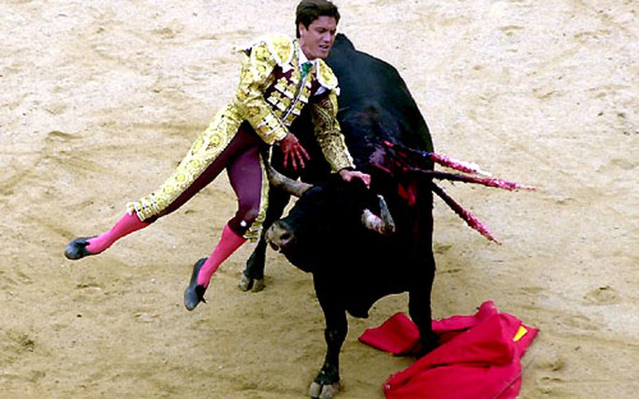 Matador Antonio Barrera is flipped by a 1,300-pound bull during a bullfight at the San Fermín Fiesta last July. The afternoon bullfights follow the morning’s running of the bulls.