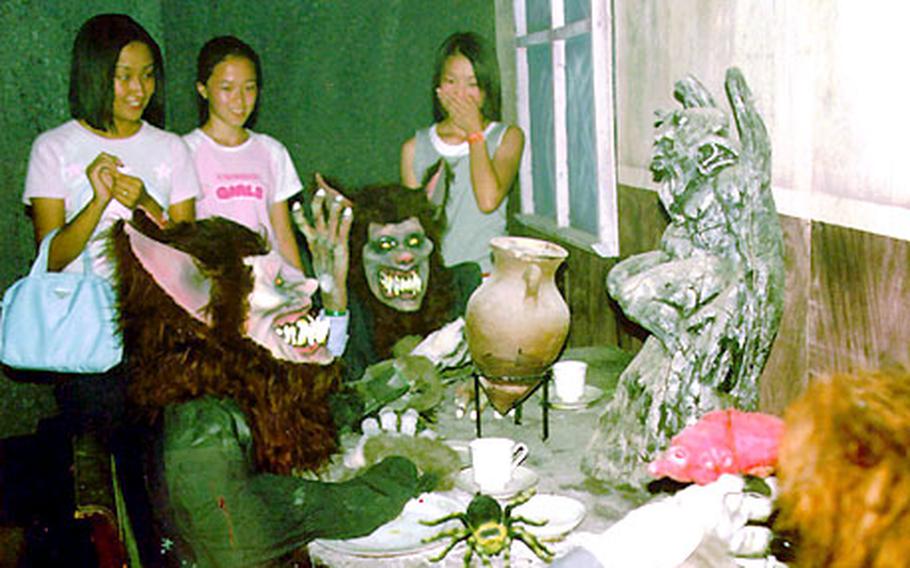 Kids take in the scary stuff at Woobang Tower Land’s Ghost House.