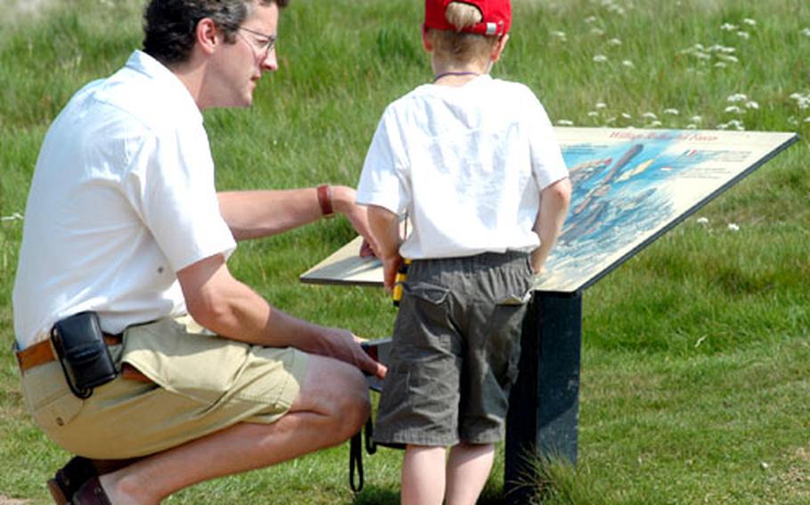 A father and son learn about the Battle of Hastings during a visit to the battlefield in Battle, England.