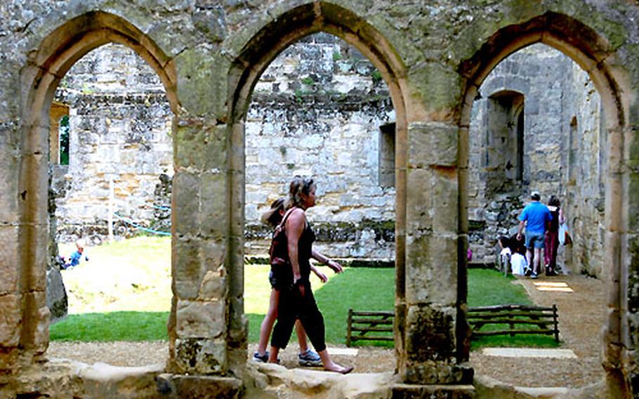 Visitors walk among the ruins inside the mighty walls of Bodiam Castle in the south of England.