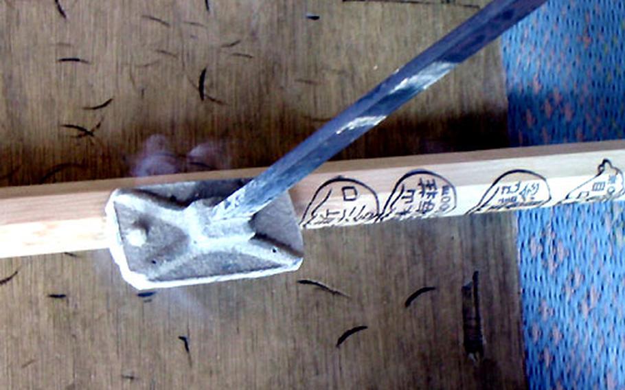A climbing stick is branded at one of the resting stations on Mount Fuji. Many climbers purchase the sticks and keep them as souvenirs.